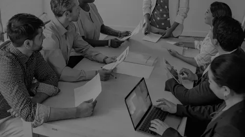 Small class of workers being lead by an instructor.