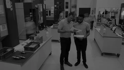 People talking and working in a clean, efficient workplace.