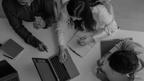Small group of workers collaborating around a table.